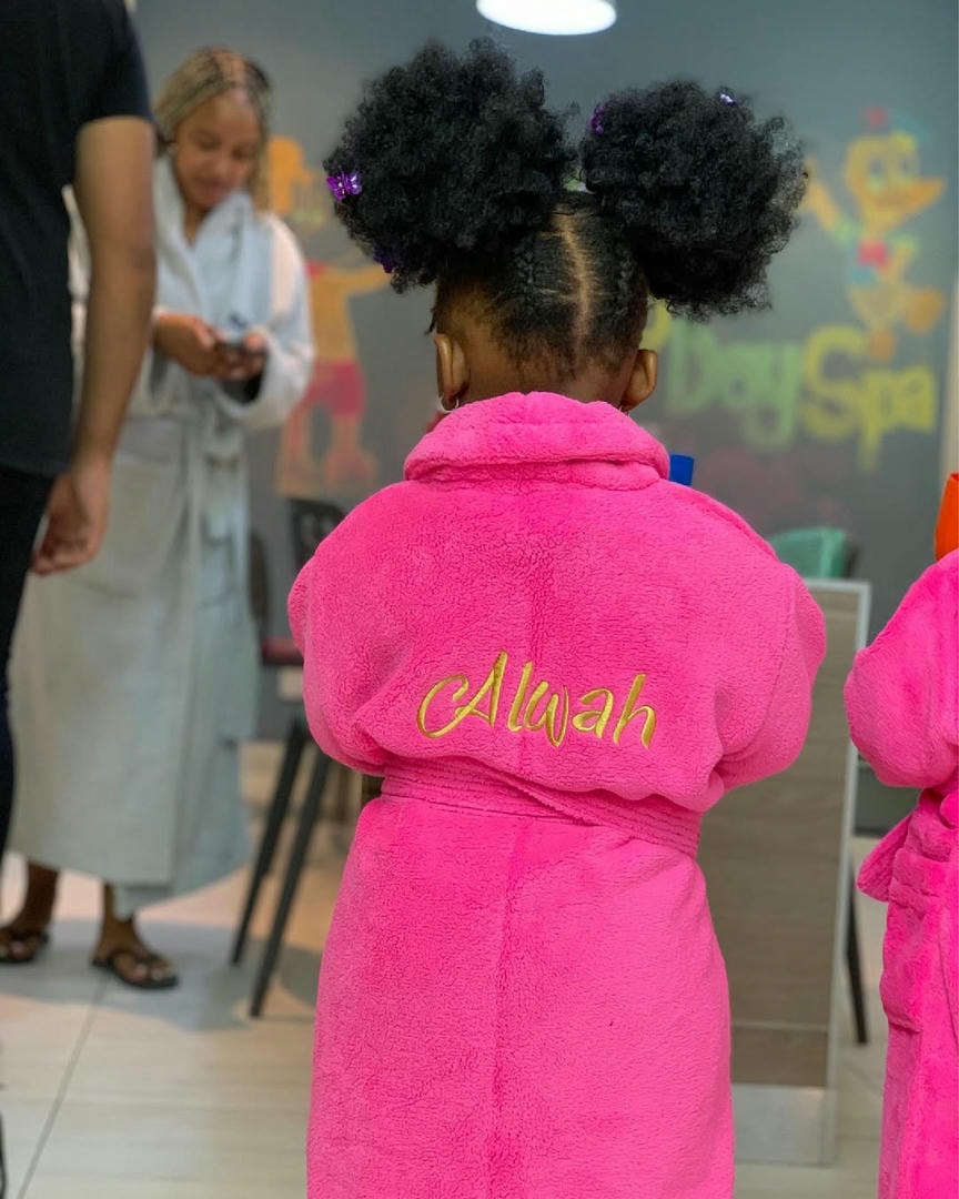 Child wearing a personalised pink spa gown embroidered with a name, at Life Day Spa Kids