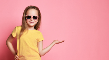 Girl in sunglasses and a yellow top against a pink background, promoting the Nail Polish Removal treatment